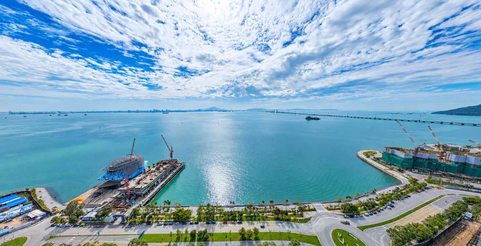 Drone photo over the site at 400 feet facing southeast, with the Penang Bridge on the horizon